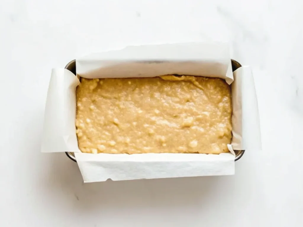 Pour batter into the prepared loaf pan
